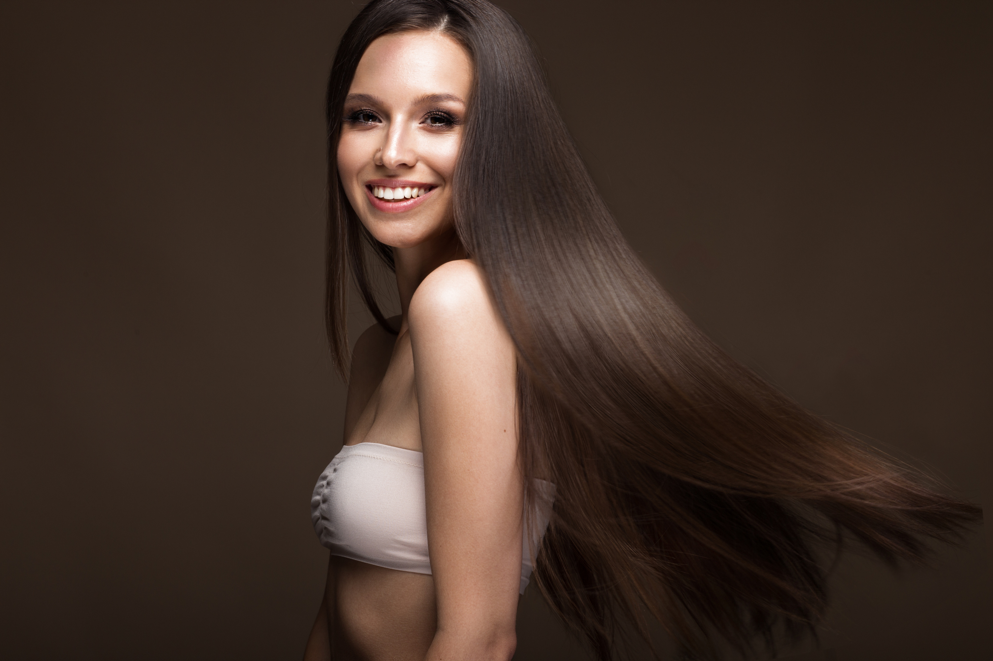 Beautiful brunette girl in move with a perfectly smooth hair