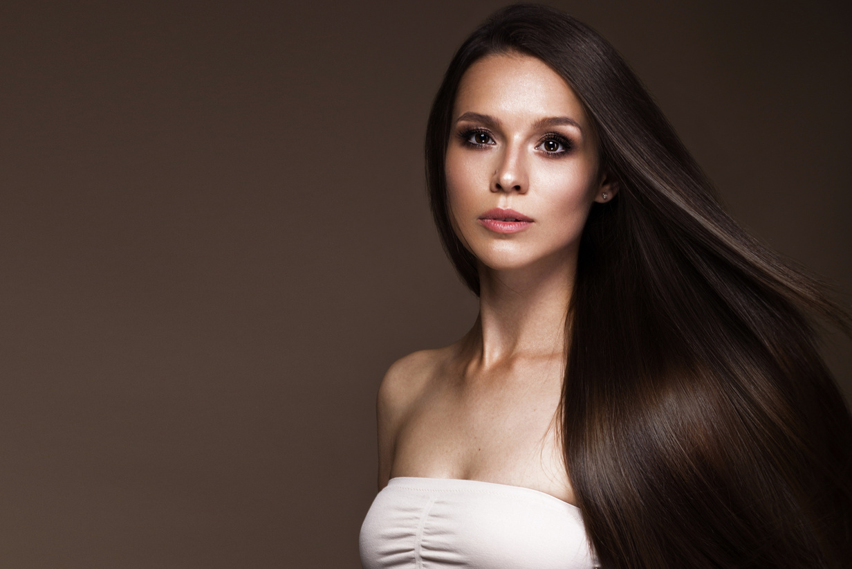 Beautiful brunette girl in move with a perfectly smooth hair